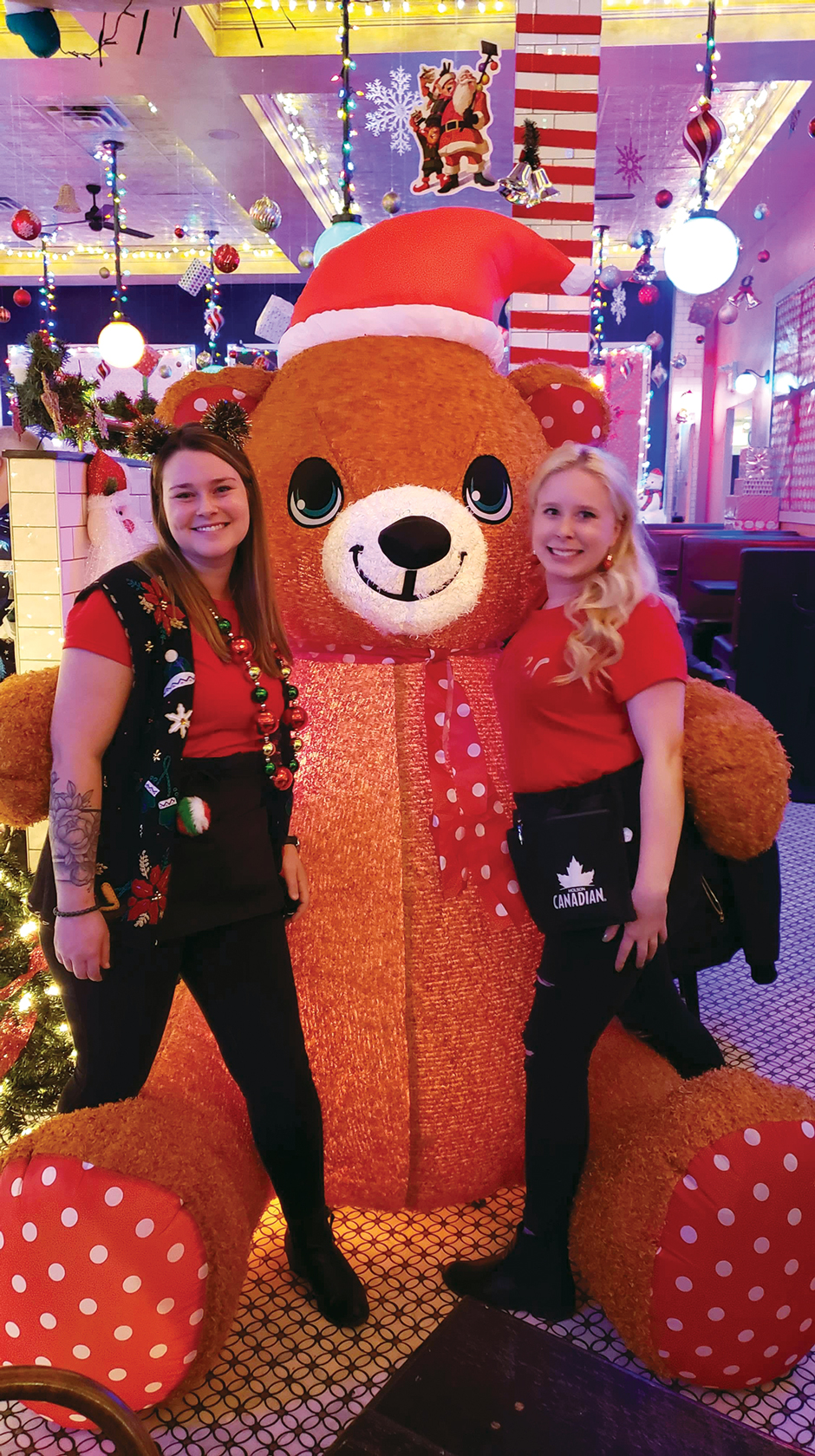 Savoy staff pose with a giant teddy bear as part of the decorations for Miracle Pop-up.