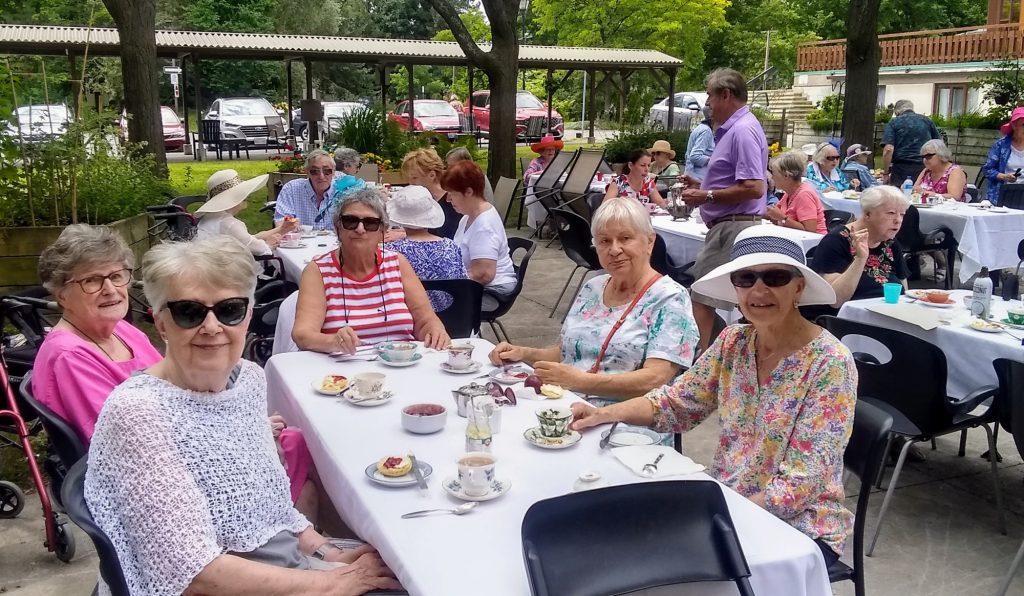 Residents sit at a table outside. 