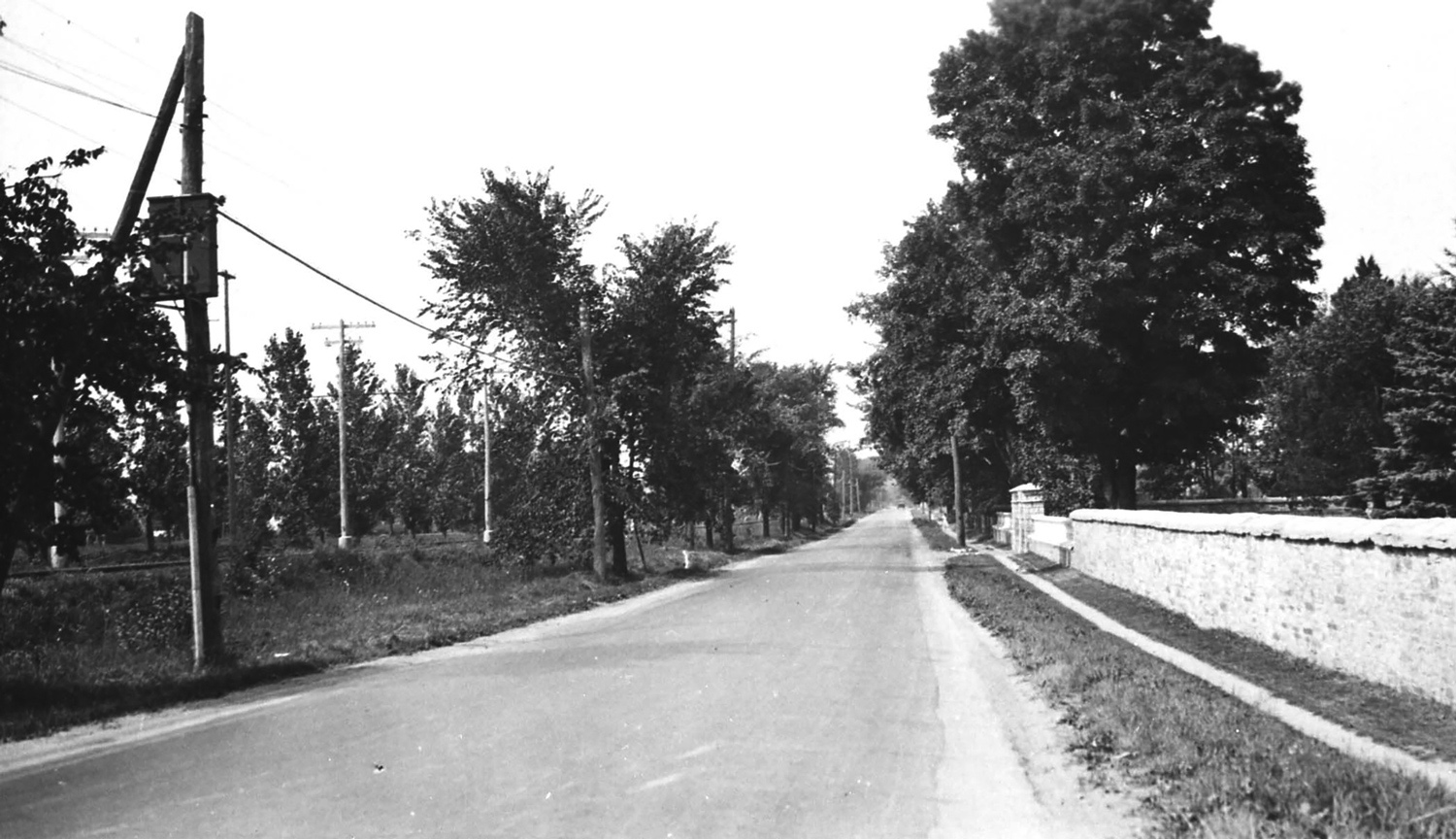 This photograph of Richmond Road from the 1920s shows the distinctive Maplelawn stone wall before Richmond Road was widened in 1931.  Photo courtesy of the City of Ottawa archives (CA-7595)