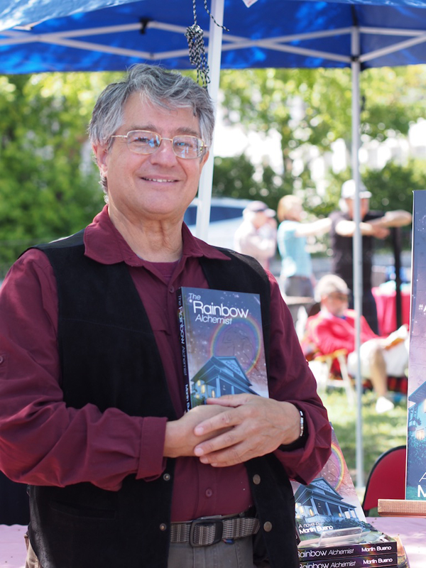 “I’ve sold three books, I’m happy.… there’s 150 authors here – some really far out authors – so if I sell 3-5 books today I’m happy,” said Martin Bueno, Kitchissippi resident and author of Rainbow Alchemist. Photo by Pearl Pirie.