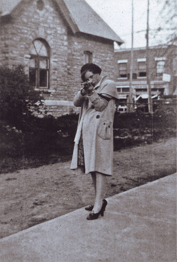 Mary Scrivener (Morgan) in 1930, in front of All Saints Church with the old town hall and Richmond Road in the background.