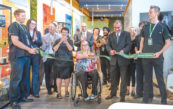 Front row (holding ribbon) from left to right is Josh Vaughan, NAC store manager; Shauna Lidtkie, patient; Gulwant Bajwa, CEO; and Maximillian Weigelt, staff member. Photo by Ted Simpson.