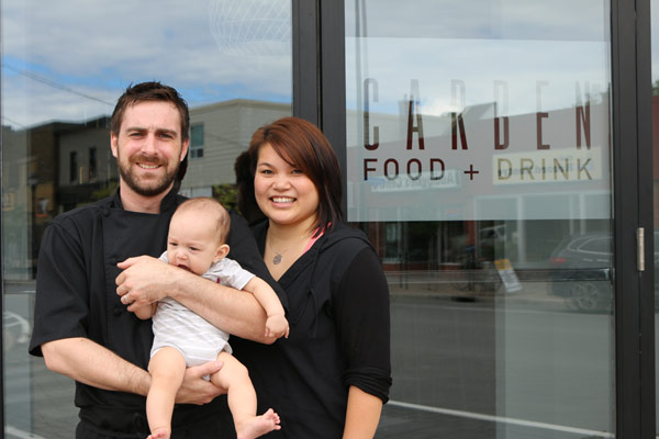 Carben Food + Drink owners Kevin Benes and Caroline Ngo with their son Kai in front of their restaurant at 1100 Wellington St. W.