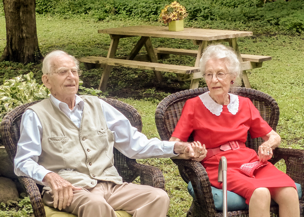 George and Jean Spear on their 72nd anniversary. Jean’s red dress and white lace collar is a replica of the dress she was wearing when they first met, many years ago on a dance floor in Kingston-on-Thames. Photo by Judith van Berkom