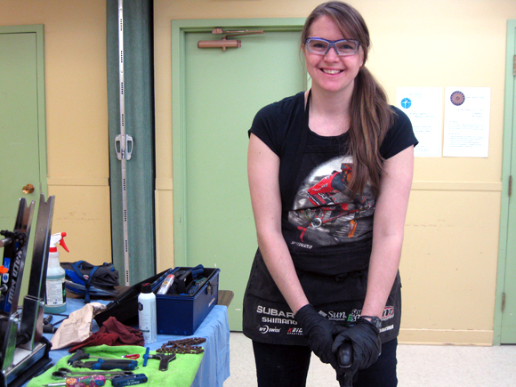  Lauren Goodhew of Westboro, in her sixteenth year as a professional bike mechanic, says fixing bikes is her job, but also her passion. She and other volunteer mechanics spruced up around 25 bikes during the “On Your Bike” event. Photo by Denise Deby.