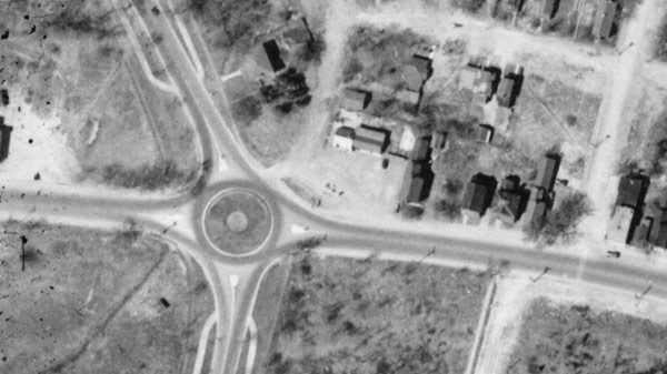 Aerial photo of the property from 1933, showing the original gas station.