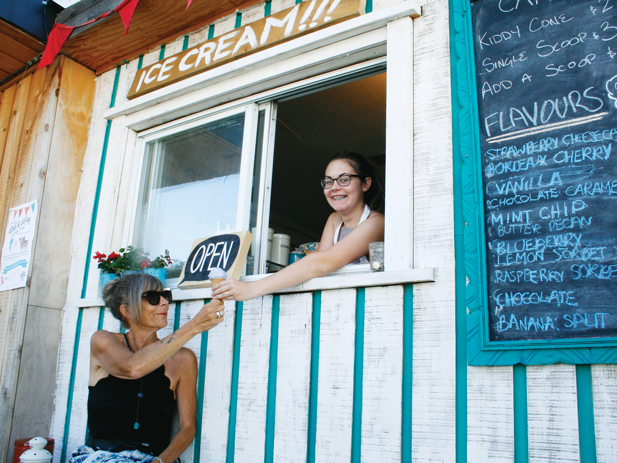 Tallie Doyle scoops a frozen treat for her mom, Andrea Stokes. Cardinal Ice Cream was one of many new shops that opened their doors in Kitchissippi this summer. Photo by Jacob Hoytema