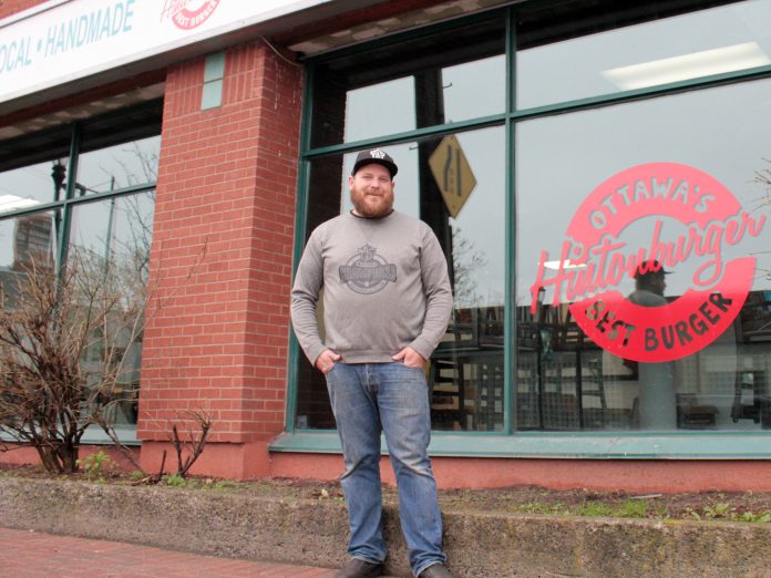 Hintonburger owner Thomas Williams stands in front of his new location at the corner of Bayswater and Somerset St.|