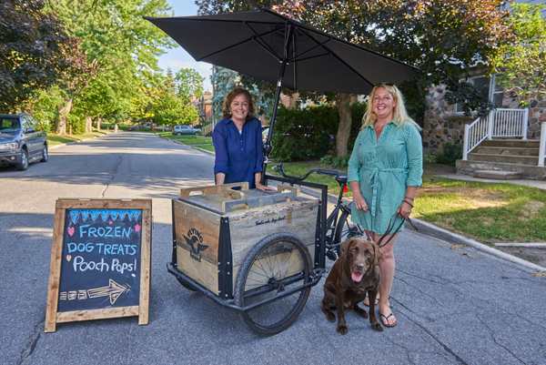 Karen Gibson and Grazyna Szawlowski with their “treat trike.” Photos by Ellen Bond