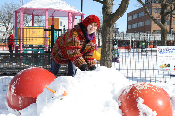  Erin Burns adds finishing touches to the back of her snow triceratops. Photo by Anita Grace.