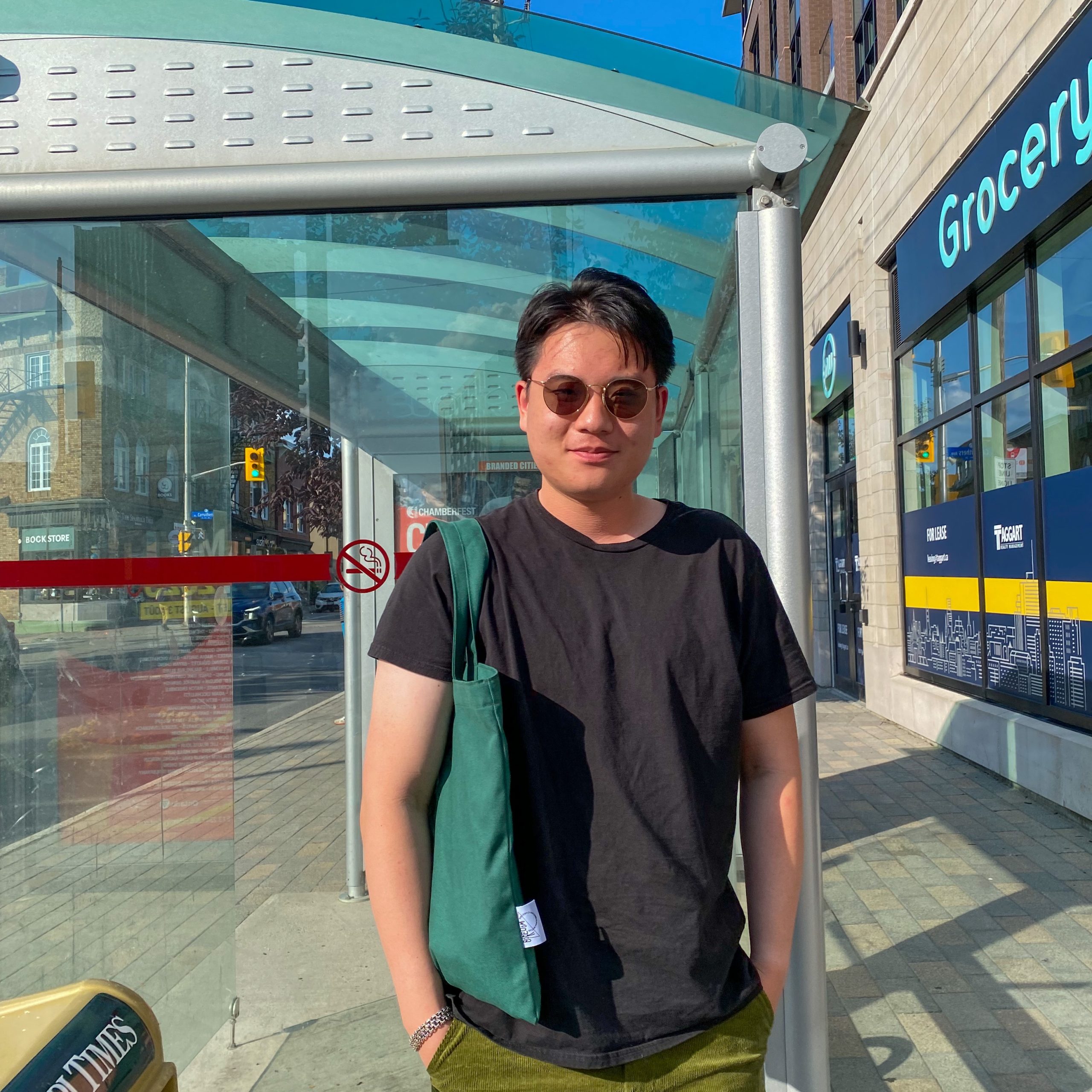 Will poses for a photo next to a bus stop on Wellington Street near the Stella Luna. 