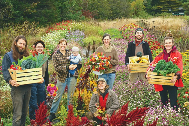 A group of people pose for a photograph in a field.