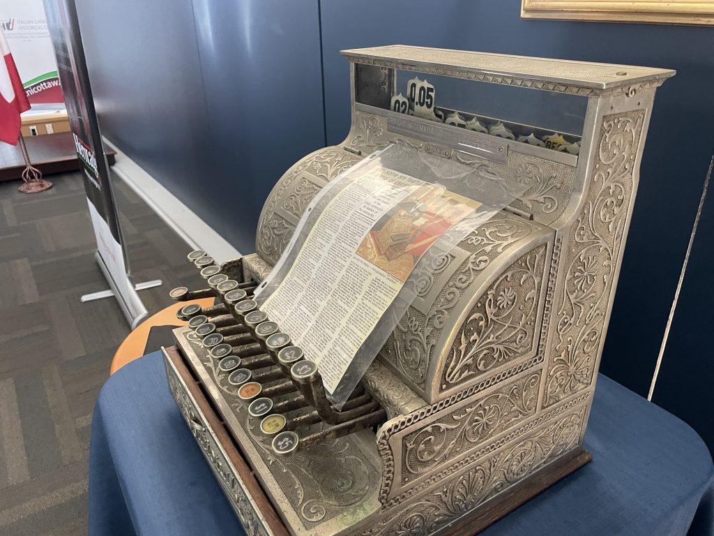 An old cash register sits on a table.