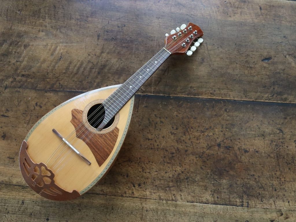 A mandolin sits on a table.