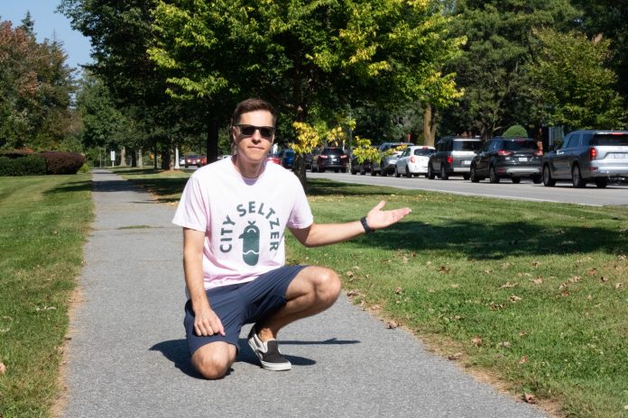 Peter kneels for a photo on Island Park Drive.