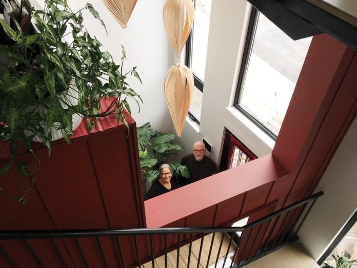 Sandra and Mark stand on the ground floor at the entrance way.